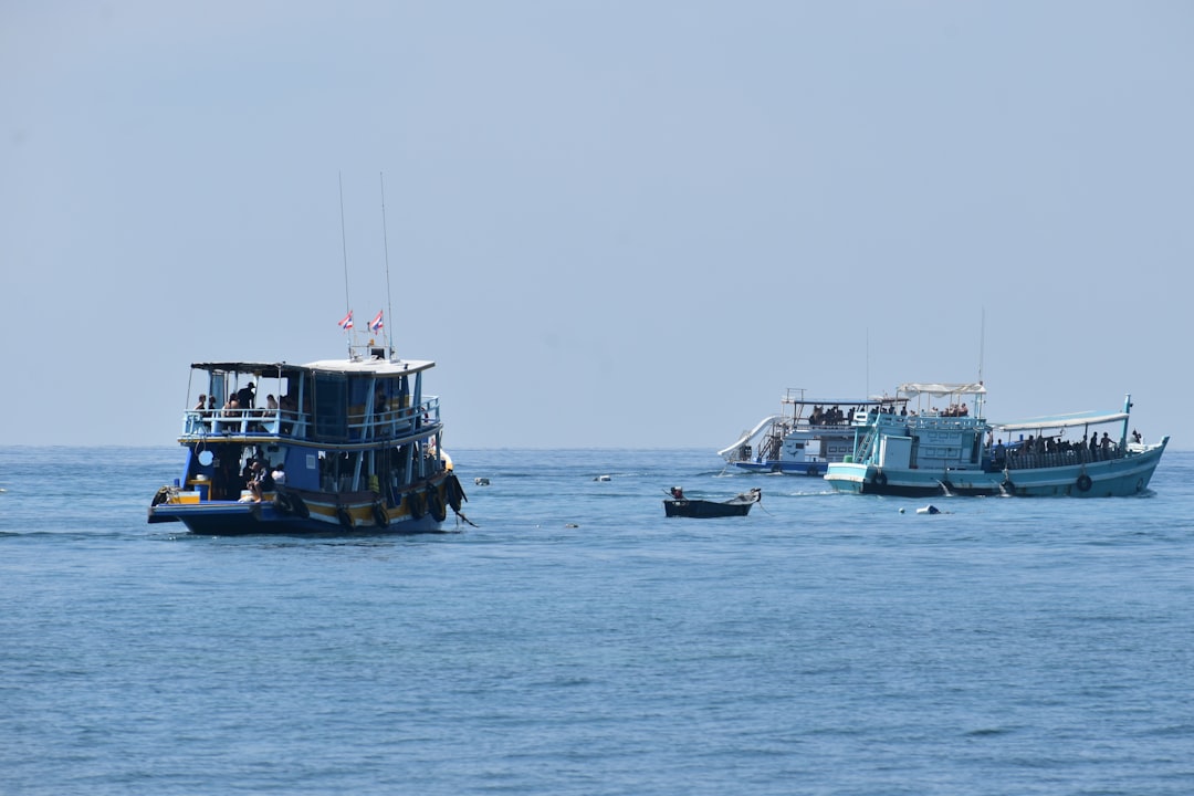 Several boats sail on a calm blue sea.